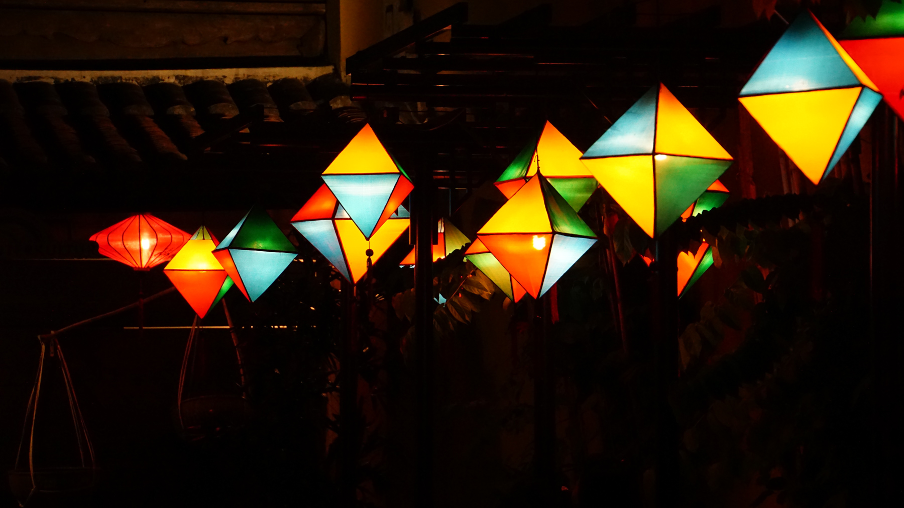 Hanging lanterns against a dark building