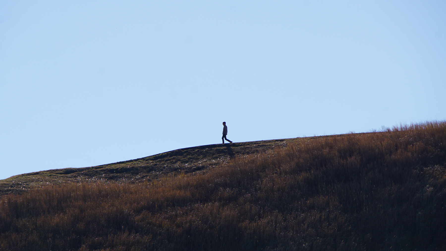 A man walking along the mountain